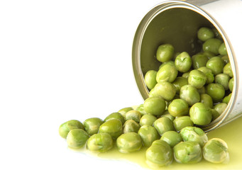 Green peas in a tin can over white background