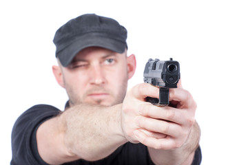 Man pointing gun, isolated on white. Focus on the gun