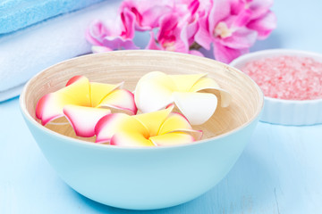 flowers in a blue bowl, towels and sea salt
