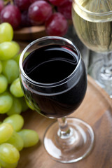glasses of red and white wine and grapes, top view