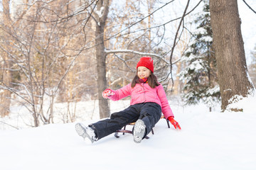 small girl sliding from hill fast.