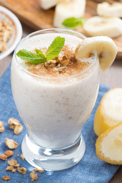 milkshake with banana, granola and cinnamon, close-up