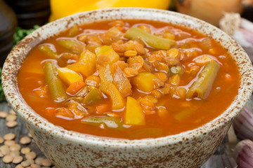 Spicy tomato soup with lentils and vegetables, close-up