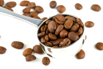 coffee beans in a spoon isolated on white