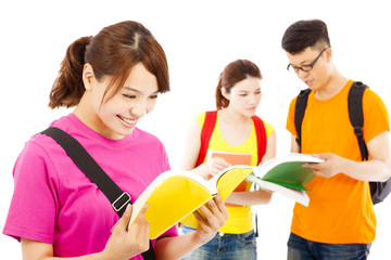 young student read a  book  with classmates