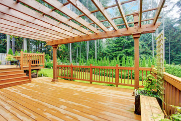 Walkout deck overlooking backyard landscape