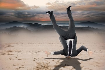 Composite image of businessman burying his head
