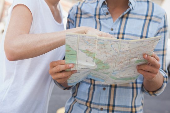 Young tourist couple looking at map