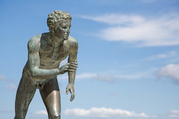 Fototapeta na wymiar A statue of 'The Runner' in the garden of Achilleion in Corfu.