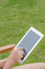 Tablet in hands outside