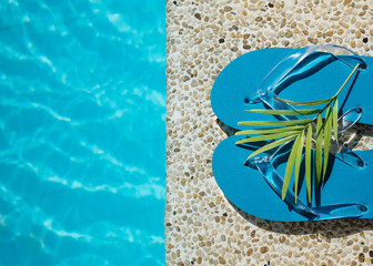 Flip Flop on  pool edge with surface of water background