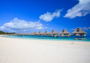 White sand beach and overwater villas in  Bora Bora