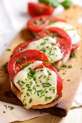 Bruschetta with fresh tomato, mozzarella cheese  and chive