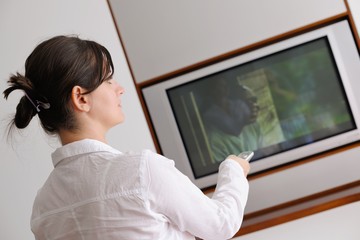 Fototapeta na wymiar young woman watching tv at home