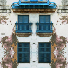 Eroded Old Havana facade with blue windows