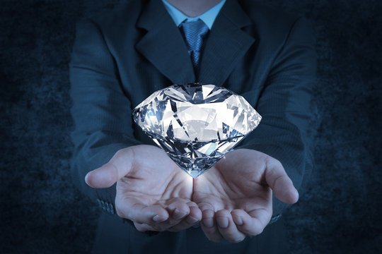 businessman hand holding 3d diamond as concept