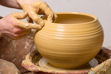 hands of a potter, creating an earthen jar
