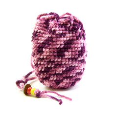 Knitted pink tone bag and bead on white background