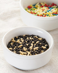 Chocolate sprinkles on white background close up