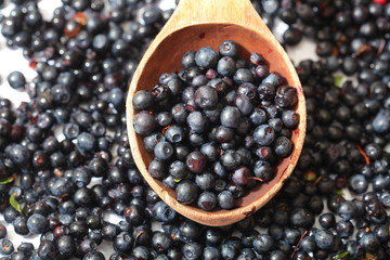 wild berry blueberries in a wooden spoon
