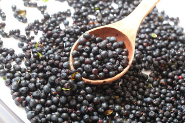 wild berry blueberries in a wooden spoon