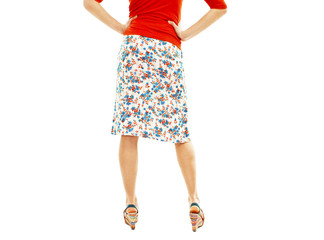 Woman wearing floral skirt and striped sandals from the back