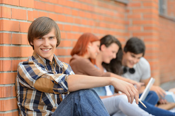 Student boy friends sitting in background