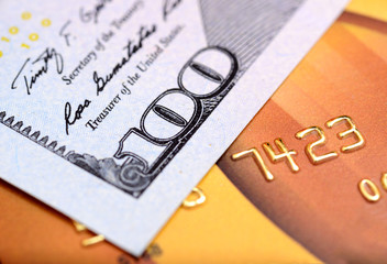 Close-up dollar note on credit card with shallow depth of field