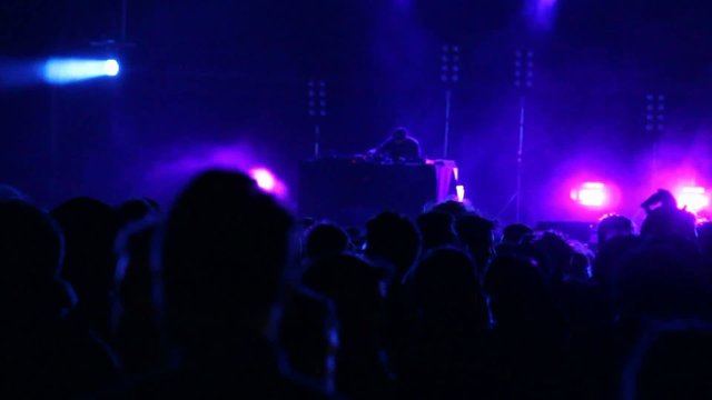 Huge crowd dancing at a DJ show, with great lightning effects
