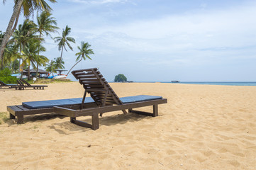 Wooden lounge with clean sand at tropical island