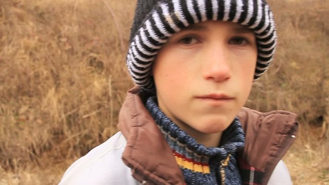 sad child looks into camera and walking away