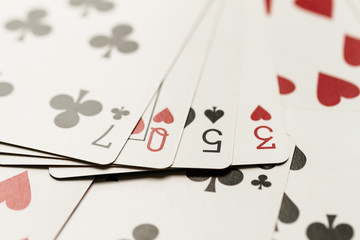 Playing card hand spelling the word lose