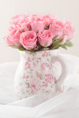 fresh pink roses in a beautiful ceramic vase