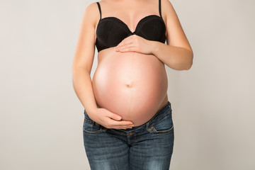 Pregnant woman with hands on her belly