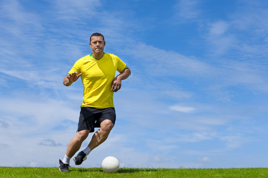 Brazilian soccer football player training on a grass pitch