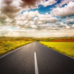 Fototapeta premium Scenery of asphalt road through agricultural fields
