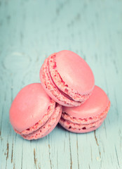 Two pink macaroons on wooden baby blue background