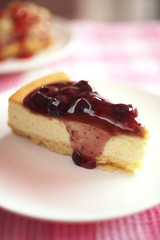 close up blue berry cheese cake in white dish