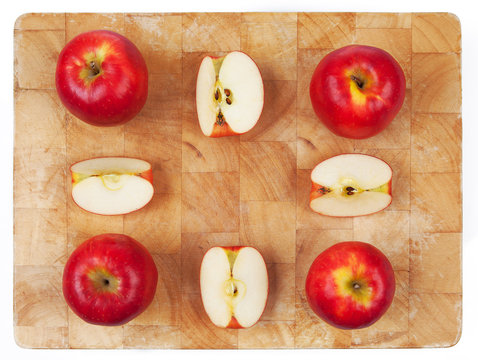 Apples cut and whole arranged on chopping board