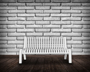 Fototapeta na wymiar White chair against brick wall 
