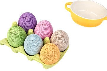 Colorful crocheted eggs in a box