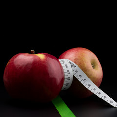 Apples with meter on dark background