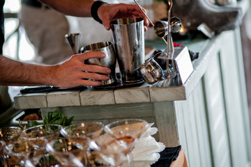 Barman pouring wine from shaker and serving it
