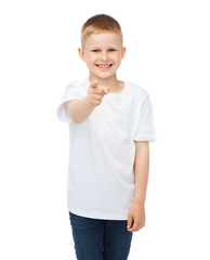 little boy in blank white t-shirt pointing at you