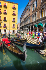 Tourists travel on gondolas at canal