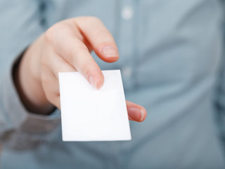 white business card in between fingers
