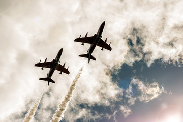 Two armed flying fighter jets in the sky