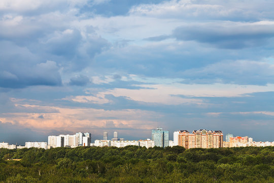 Blue Clouds In Pink Sky Over City