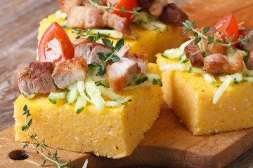 Polenta with bacon, vegetables and thyme on wooden board