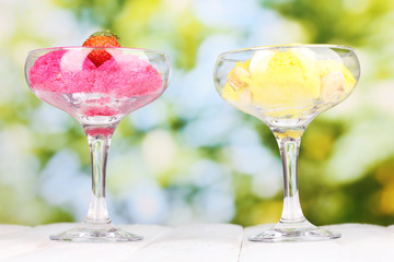 delicious ice cream on wooden table on bright background